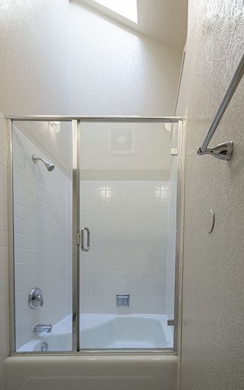 a bathroom with a shower and a tub